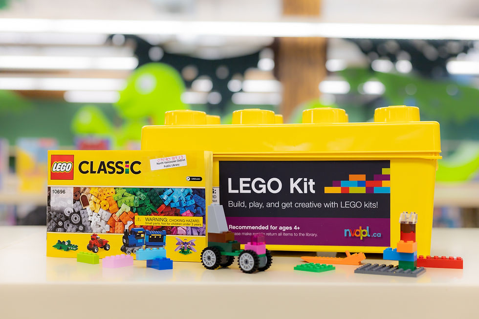 A LEGO Classic kit displayed on a table, featuring a yellow storage box with "LEGO Kit" written on the front and various colorful LEGO bricks scattered in front. 