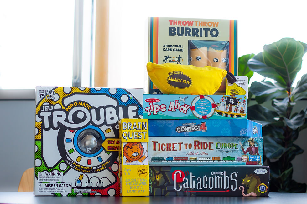 A play of different board games. A few are stacked on top of one another while others are positions facing the viewer.