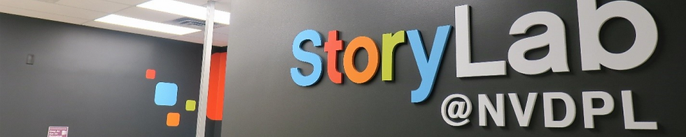 A sign for storylab is mounted on a dark wall.