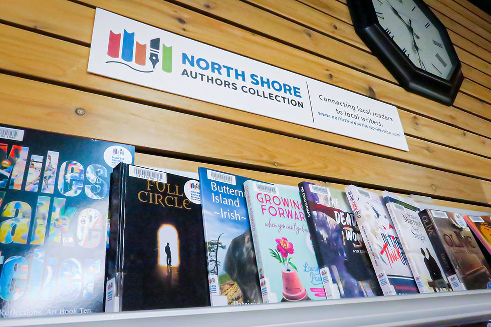 A display of books with a sign saying "North Shore Authors Collection" hanging above.