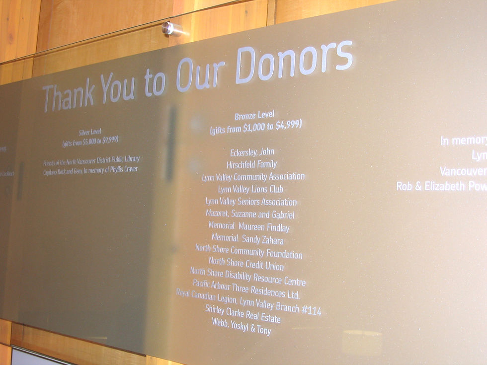 A glass board with "Thank You To Our Donors" and a list of NVDPL donors.