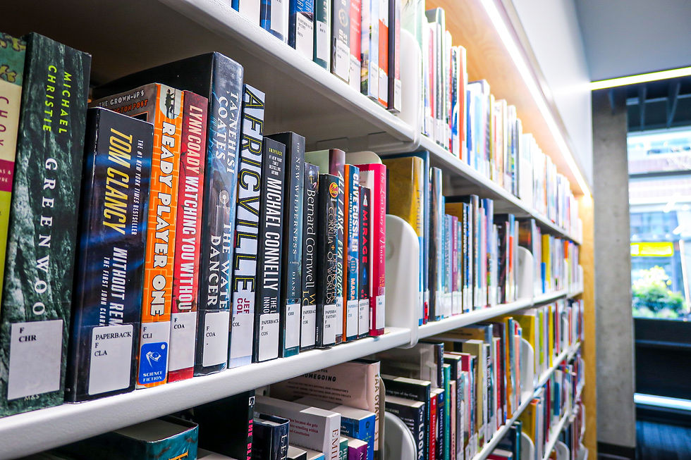 The spines on books on a shelf.
